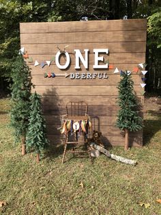 a wooden sign that says onederful with clothes hanging on it