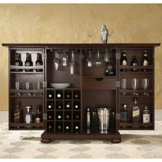 a wooden cabinet filled with lots of bottles and glasses