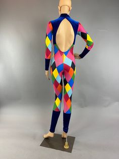 Step into the new trend with our Harlequin costume – a spandex jumpsuit. This bodysuit is not just exotic dancewear; it's a statement piece for circus performers and dancers alike.Fabric:Crafted from high-quality, long-lasting print Lycra with 4-way stretch. dark blue stretch velvet. Experience the super soft and super bright feel!Design:Featuring a total neck with open back .and long sleeves, this jumpsuit is both stylish and comfortable.Custom Orders:Tailor this piece to your perfection! Send Stretch Rave Unitard For Costume Party, Rave Style Stretch Unitard For Costume Party, Stretch Dancewear Bodysuit For Costume Party, Multicolor Stretch Rave Unitard, Multicolor Fitted Rave Unitard, Multicolor Bodysuit For Club, Fitted Multicolor Bodysuit For Club, Fitted Multicolor Unitard For Party, Harlequin Costume