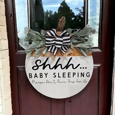 a sign that says shh baby sleeping hangs on the front door