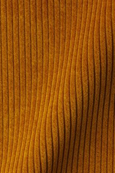 the texture of an orange fabric is very close to it's surface and looks like waves