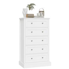 a white dresser with drawers and a potted plant