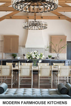 an open kitchen and dining room with chandelier above the island in this modern farmhouse style kitchen