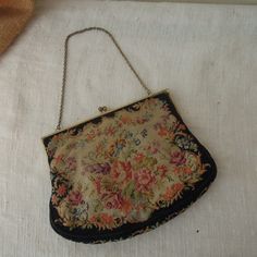 "Vintage Black Floral Petite Point Purse / Black Handbag 1920's / Floral And Brass Clasp Evening Bag Beautiful black clutch with a garden rose design petite point purse. The clasps is ornate gold metal with 2 green stones. Cream satin interior is in good condition with one pocket and change purse. In good vintage condition. Measures approx: 6 1/4\" x 5 1/2\" This is a vintage item , sold as is with its original charm and patina." Black Vintage Bags For Vintage Events, Vintage Black Bag For Vintage Events, Black Victorian Bag For Vintage Events, Victorian Style Black Bag For Vintage Events, Black Rectangular Bag For Vintage Fashion, Victorian Black Rectangular Bag, Vintage Black Pouch Evening Bag, Elegant Black Bag For Vintage Fashion, Black Victorian Style Bags For Formal Occasions