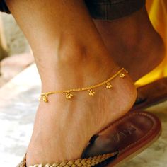 An Indian design with lovely shiny small gold beads/bells dangling in bunches of 3 on a dainty chain. Handcrafted with love and care, this is a very comfortable bracelet and a beautiful anklet. A perfect accessory for everyday wear. Lightweight and stylish..! * Gold Weight - 4.6 gms (length 7 inches) * Bracelet Length - 5 to 10 inches (Not including extra links) Find us on Instagram for exquisite designs: @abhikajewels Like us on Facebook: www.facebook.com/Abhikajewels Thank you for visiting our Gold Anklet For Wedding With Ankle Strap, Gold Anklet With Ankle Strap For Wedding, Gold Wedding Anklet With Ankle Strap, Adjustable Traditional Anklets For Puja, Traditional Anklets For Puja, Traditional Toe Ring Anklet As Gift, Traditional Anklets With Latkans For Gift, Festival Anklets With Latkans As A Gift, Festival Gift Anklets With Latkans