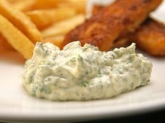 a white plate topped with fries and dip