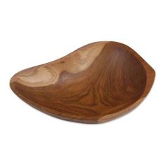 a wooden bowl sitting on top of a white surface