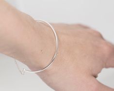 This minimalist bracelet cuff made of sterling silver wire. The chain that attached to the bracelet and lock is also sterling silver. Its edgy and minimalist style fits well with casual fashion. Perfect as a gift to a stylish girl or woman. If you like simplicity and minimalism, this piece is for you! Measurements: wire width 1.5 mm. <3 Please provide me with your size! I will need a circumference of your wrist. You can take a thread, wrap it around your wrist and measure the size on a ruler. Minimalist Silver Bracelet With Simple Design, Minimalist Cuff Bangle Bracelet, Minimalist Silver Alloy Bracelets, Minimalist Silver Bangle, Sterling Silver Bracelets With Simple Design, Minimalist Sterling Silver Bracelets For Everyday, Everyday Sterling Silver Bracelets With Simple Design, Minimalist Sterling Silver Bracelet, Silver Minimalist Bangle For Everyday