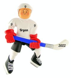 a christmas ornament with a hockey player holding a blue and white stick in it's hands