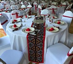 the tables are set with white and red linens