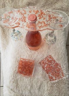 a table topped with dishes and drinks on top of a white rug covered in confetti