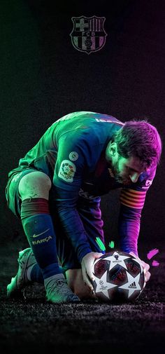 a man kneeling down holding a soccer ball