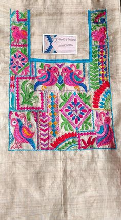 a piece of cloth that has been embroidered with different colors and designs on the fabric