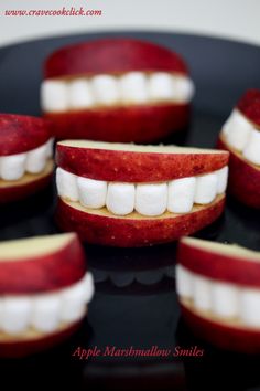 apple marshmallow smiles are arranged on a black plate