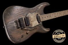 an electric guitar that is made out of wood and has been engraved with the words guitar company