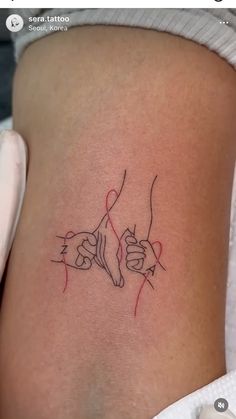 a woman's thigh with two hands holding each other in the shape of a heart