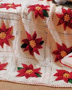 a crocheted blanket with poinsettis on it