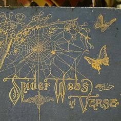 an old book with spider webs and flowers on it