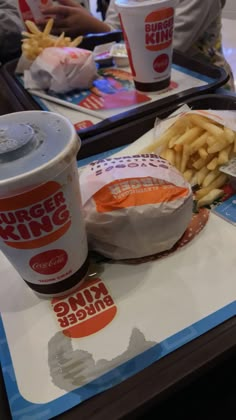 two trays with burger and fries on them at a fast food restaurant in china