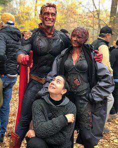 three people dressed up in costumes standing next to each other and posing for the camera