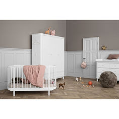 a baby's room with white furniture and accessories