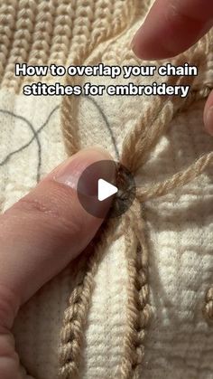 someone is stitching on the side of a sweater with their thumb and thumbnails