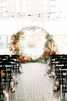 an outdoor ceremony set up with chairs and candles