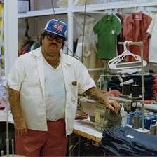 a man standing in front of a sewing machine