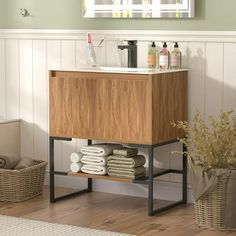 a bathroom with a wooden cabinet and white towels