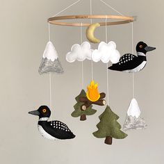 a mobile with birds and trees hanging from it