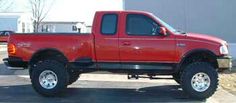 a red pick up truck parked in a parking lot