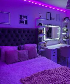 a bedroom with purple lighting and pink bedding