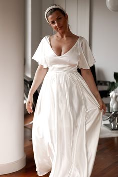 a woman in a white dress is walking