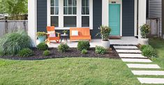 a small house with two chairs on the front lawn