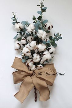 a bunch of cotton flowers tied to a burlock