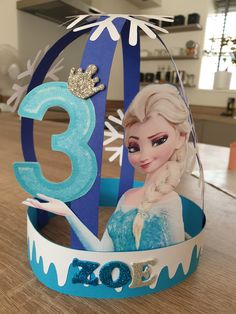 a frozen princess tiara with the number 3 on it and an ice queen figure