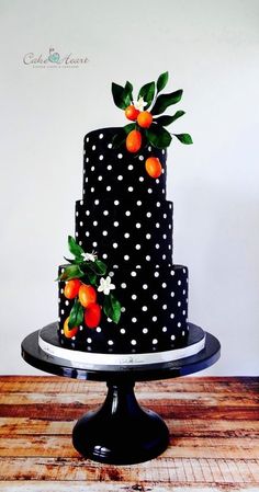 a black and white polka dot cake with oranges on top