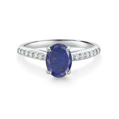 a white gold ring with an oval shaped blue sapphire and diamonds on the sides, set in