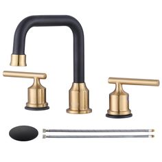 the brass faucet with black handles is shown