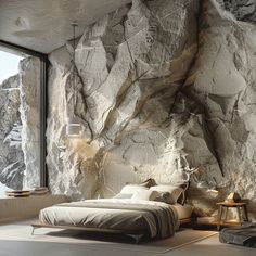 a bedroom with large rocks on the wall and floor to ceiling windows, along with a bed