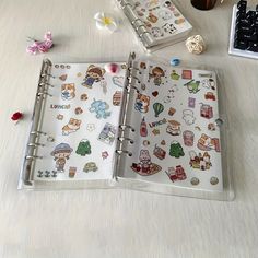 an open planner book with stickers on it