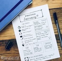 a printable planner is sitting on top of a desk next to a notepad