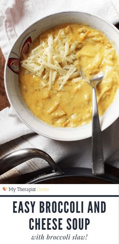 a bowl of broccoli and cheese soup with a spoon in it on a table