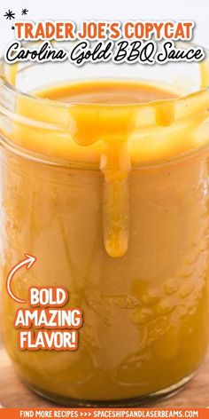 a jar filled with liquid sitting on top of a wooden table next to an orange sign