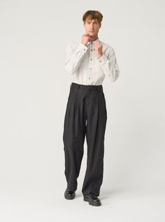 "Exquisite linen trousers for men -- flowy, pleated, and packed with details that ensure impeccable fit. Offered in heavy-weight linen. If you're interested in a medium-weight option, you'll find another THEO listing in our MEN'S section. STYLE DETAILS  * Relaxed fit * Wide, straight leg * High waist with elasticated back  * 2 front pleats * Fastens with 2 buttons and a zipper * Side pockets * Full length * Made from heavy-weight linen SIZES & COLORS IN PICTURES * Model wears size L in color Black Heavy and size M in color Magnetic Blue. He is 188 cm (6'2\"). Chest - 97 cm (38\"), waist - 83 cm (33\"), hips - 97 cm (38\"). NOTES ON SIZING & COLORS * Please note that linen shrinkage during the softening process cannot be predicted precisely. Therefore, each piece in the same size can vary 1 Mens Flowy Fashion, Male Linen Pants, Wide Trousers Outfit Men, Wide Pleated Pants Outfit Men, Relaxed Pants Outfit Men, Wide Leg Trousers Outfit Men, High Waisted Trousers Men, Wide Fit Pants Men, Types Of Pants Men