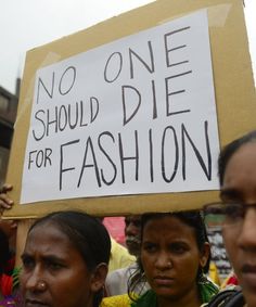 two women holding a sign that says no one should die for fashion