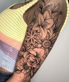 a woman's arm with flowers on it