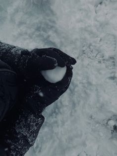 someone standing in the snow with their feet up