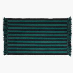 a green and black striped rug with fringes