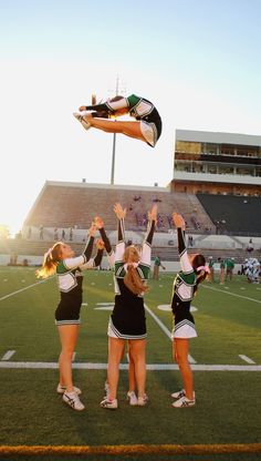 the cheerleaders are doing tricks on the field